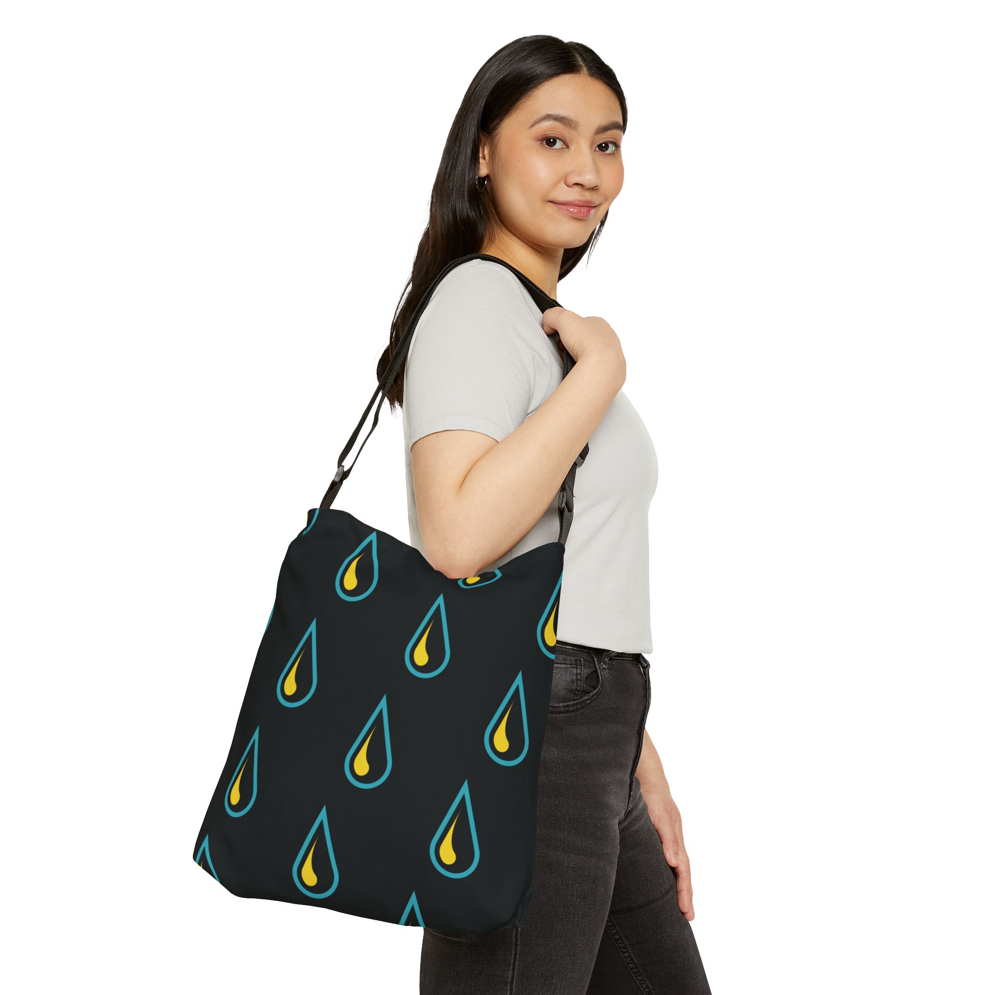 View of a woman holding the CHANNEL tote with the drops pattern side showing.